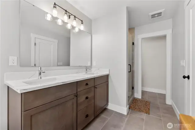 Double vanity and plenty of light in the en suite.