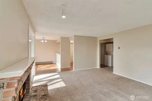 The entry opens to a living room flooded with natural light and gorgeous landscape views! Enjoy cozy nights by the wood-burning fireplace!