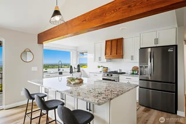 Sleek and functional kitchen featuring a spacious island and brand new stainless steel appliances.