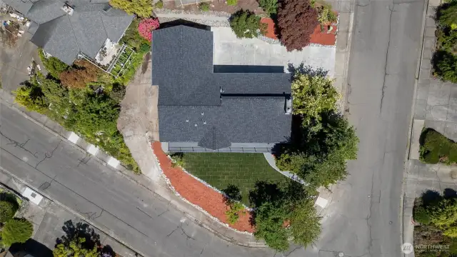 Aerial view reveals additional parking or project space on former driveway pad—bring your vision and make the most of this flexible lot.