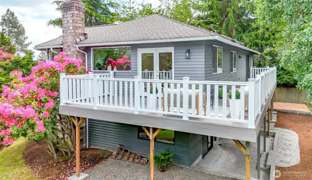 Wrap around deck and manicured yard.
