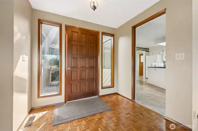 Right from the front door, this home delivers vintage charm that doesn’t feel dated. The original 15-panel wood door is flanked by portrait windows, bringing in the light without sacrificing privacy or personality. Inside, the herringbone-patterned wood floor is one of those rare design choices that feels both thoughtful and totally unexpected. It’s a nod to craftsmanship, and a quiet moment of cool before the rest of the house starts showing off.