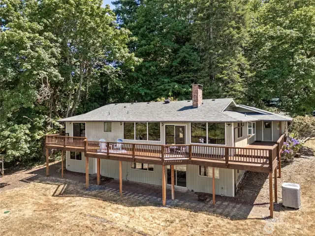 With direct access from the main living area, this deck makes outdoor living easy. There’s plenty of room for seating, grilling, or just enjoying the breeze off the water. Towering trees provide privacy and a constant connection to nature. It’s the kind of space that feels like a retreat without needing a vacation.