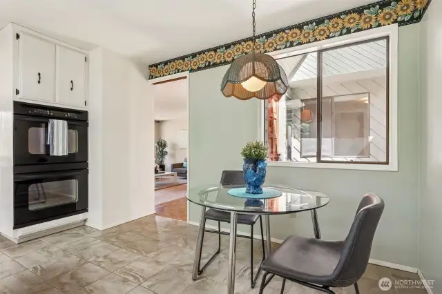 This space balances purpose and comfort. The windowed nook brings in soft natural light and a direct line of sight to the home’s front approach, while the double ovens handle everything from holiday hosting to weeknight dinners with zero fuss. Overhead cabinets complete the setup.