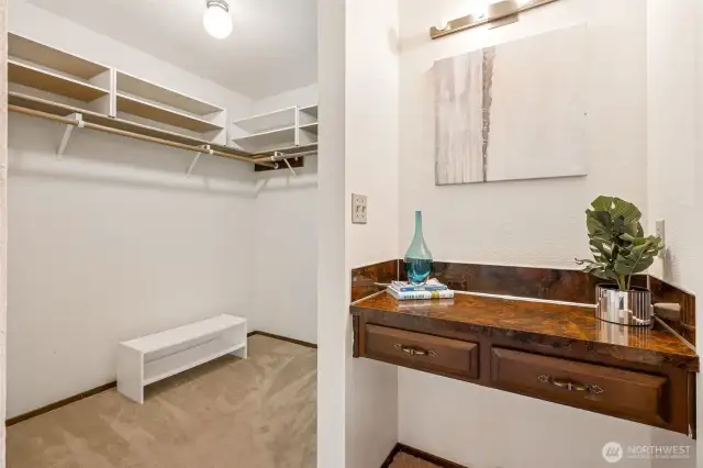 This walk-in closet has the comfort covered with plush carpet underfoot and plenty of space to move. Just outside, a vintage vanity counter with two drawers adds a fun twist. It works as a getting-ready station, but could just as easily become your morning coffee corner or a laptop landing spot. Good design leaves room for interpretation, and this space delivers.