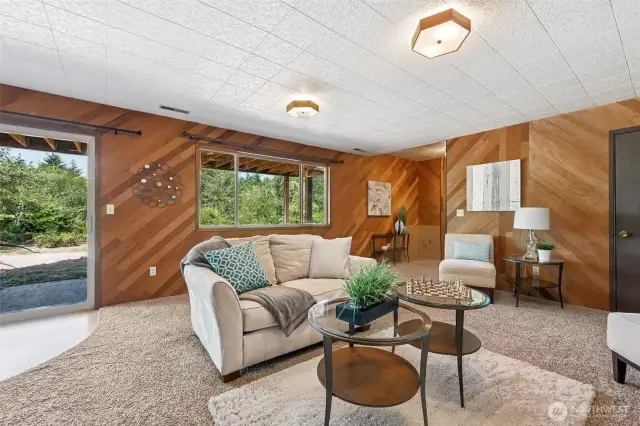 Natural light and access to the outdoors make this lower-level space feel anything but secondary. A full-sized picture window and sliding glass door open up the room, while the original diagonal wood paneling brings texture and a hit of retro charm. It’s a great setup for multi-generational living, a creative workspace, or a future short-term rental. The layout’s already doing the work, you just decide how to use it.