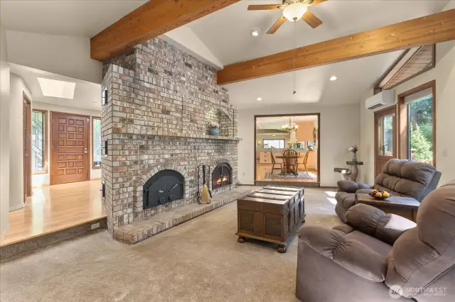 Vaulted ceilings & exposed wood beams perfectly highlight your beautiful brick fireplace. A Russian fireplace keeps you warm & cozy during the cold & rainy months as it radiates heat throughout.