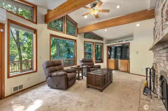 A window wall floods lots of natural light into your living room and the scenic backdrop of the PNW offers an abundance of privacy. Your sunken living room is an ideal entertaining room offering a wet bar with built-ins & a door that leads out to your expansive deck.