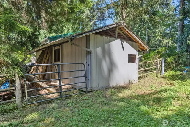 A 2 stall barn with a small pasture area for grazing.