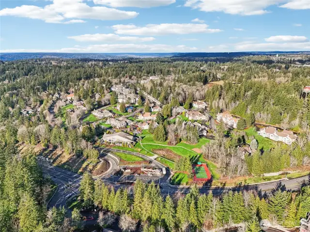 Aerial view of the community, entrance, pickle ball court and clubhouse.