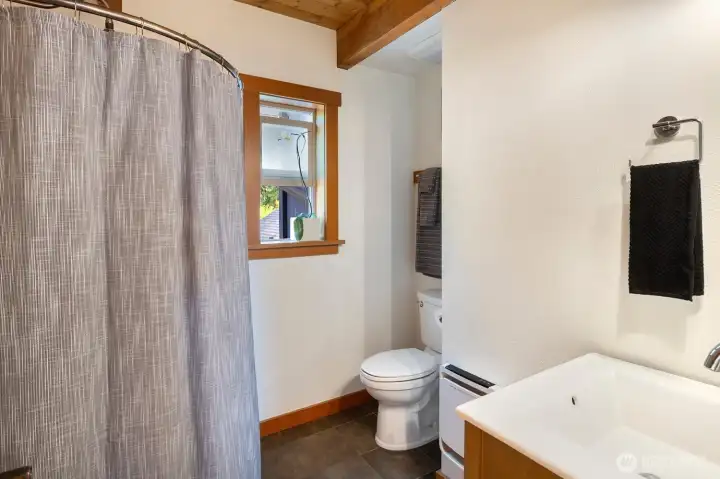 Main level 3/4 bath sits right next to the main level extra finished room.