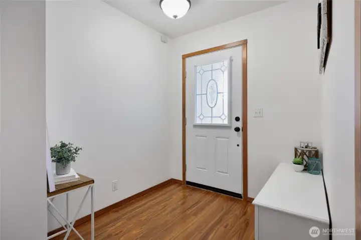 Bright entry is a wonderful landing spot to welcome guests and friends, with enclosed mini-blinds inside the beveled glass of the door for light and privacy options.