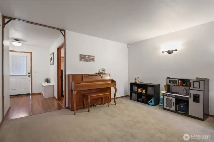 Dining area here currently used as music and play space, but certianly plenty of room for a dining table and hutch.