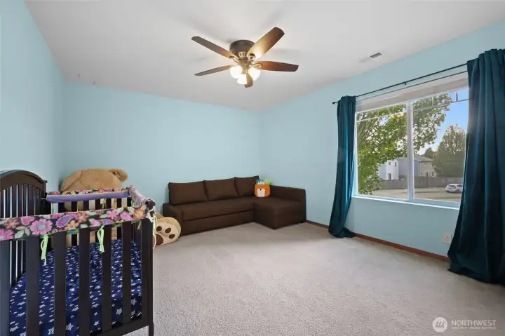 Bedroom #2 offers a front yard view and also has a ceiling fan...