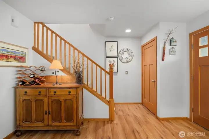 Back in the front entry, the stair railing matched the doors and trim, as it is made of fir. There is a generously sized coat closet, as well.