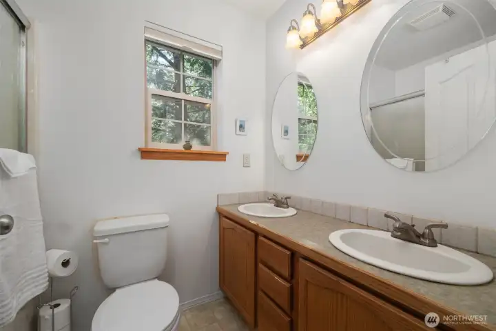The primary bath has a large dual sink vanity with separate mirrors.
