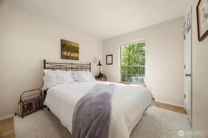 The fourth bedroom looks to the forested land on the side of the home and is very private.