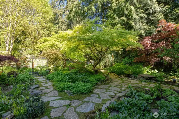 There is no grass to mow and flagstone walkways throughout the fully fenced upper garden.