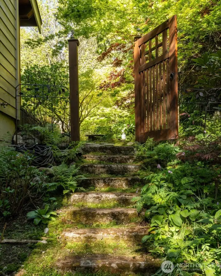 There is a stone stairway down from the upper garden to the lower level and the unfinished basement.