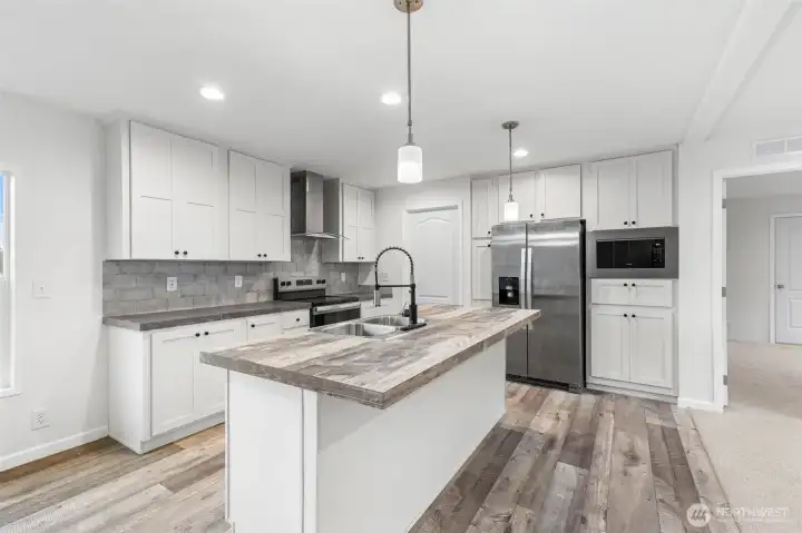 Well-appointed kitchen with a large eat-in island and plenty of cabinets for all your needs.