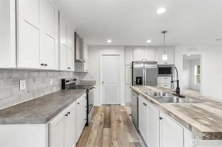 The door is the entry into the utility room and backdoor which leads to the back yard.