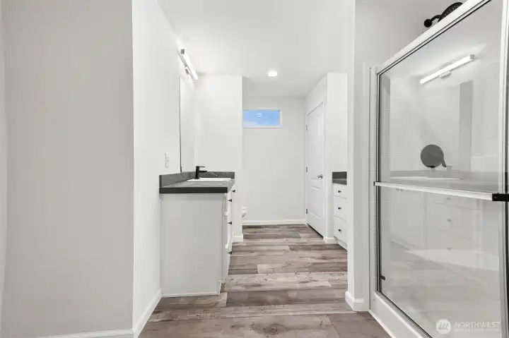 Large primary bath with separate his/her sinks and a walk-in shower.