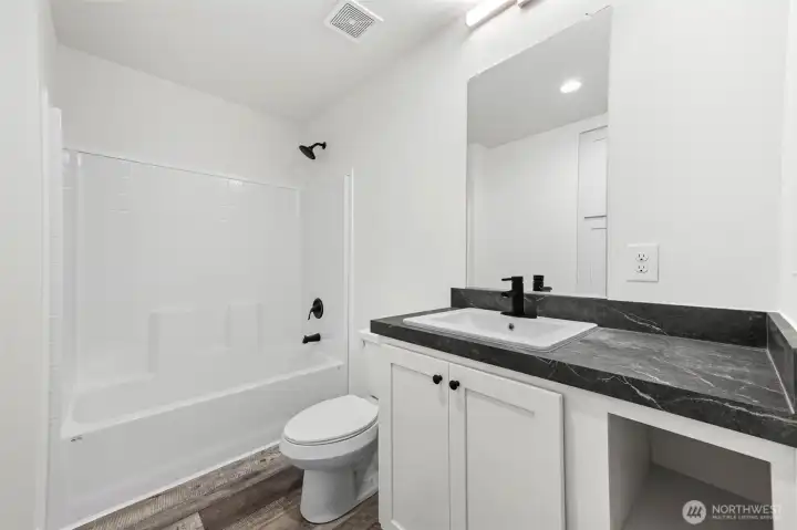 Guest bathroom off the hallway to three bedrooms