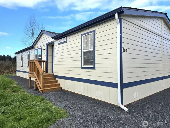 Welcome to 164 Nix Lane. The inviting front entry with a clean, updated look with gravel walk for easy low-maintenance care.