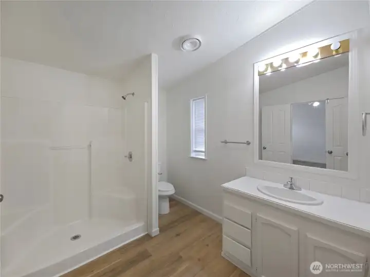 Primary bath featuring an oversized shower and a convenient linen closet for added storage.