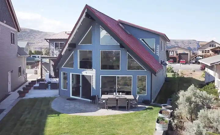 View of the cowl style home with double sliding door. Views out evey window.