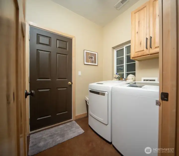 Roomy laundry room, with a door to the garage.