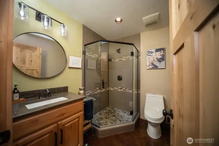 Custom half bath on the main floor. Glass and tile
