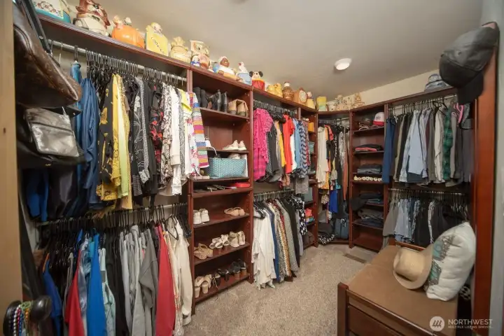 Walk in closet with custom organizers.