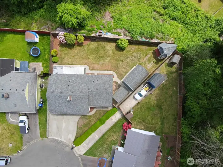 View of the large pie shaped lot with green space behind the house for privacy.