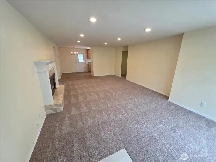 Front entry to large living room and dining room with gas fireplace.