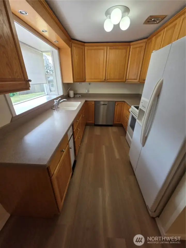 View of kitchen with large window facing the huge back yard.