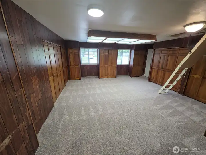 View of the great room with pull down ladder going to attic for storage or a play space?