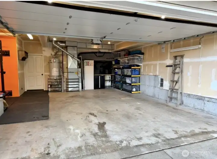 This oversized garage is big enough for 2 cars, a home gym, and additional storage. This oversized garage is big enough for 2 cars, a home gym, and additional storage.
