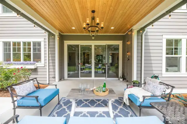 The covered outdoor living space extends the entertaining from the massive family room & kitchen.