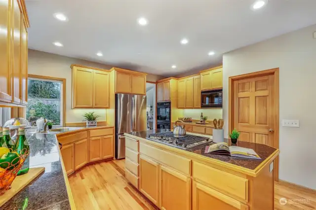 Designed for cooking enthusiasts, this kitchen includes double wall ovens, perfect for meal prep and hosting gatherings. The custom cabinetry extends to the ceiling, maximizing storage and adding a touch of elegance.