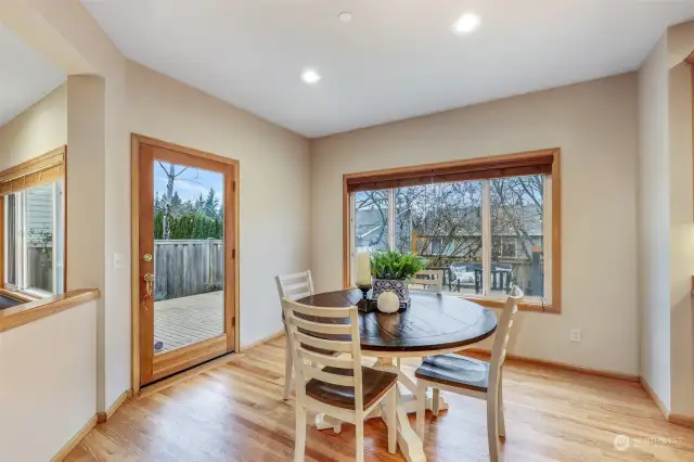 Enjoy your morning coffee or family meals in this cozy dining nook, surrounded by large windows that overlook the private backyard. A glass door leads to the outdoor deck, making indoor-outdoor living effortless.