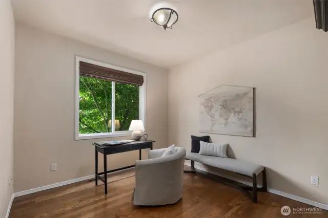 Office with hidden bookshelf/walk in safe closet.