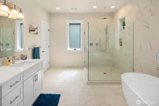Enter the luxurious primary bath, with heated floors, oversized shower, and deep soaking tub.
