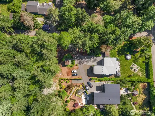 Aerial perspective shows this shy-acre corner lot in all its verdant glory!