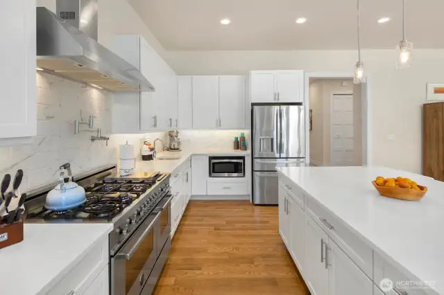 Stainless steel appliances, including 6-burner Bertazzoni range and double oven.
