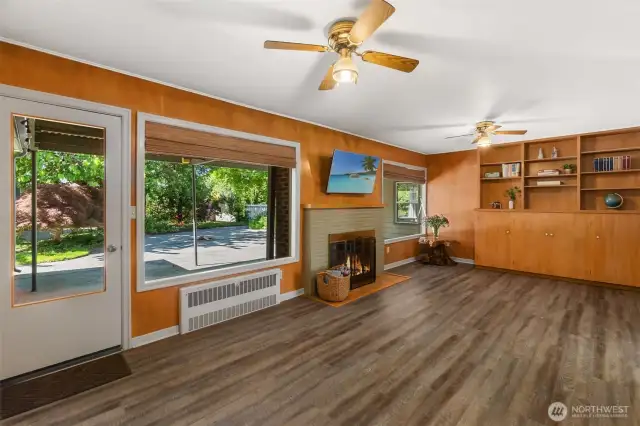 Lovely family room with built-in-bookcase and fireplace overlooks the covered backyard patio. Or, use this space as an office, library, playroom, craft room, etc.  The possibilities are endless.