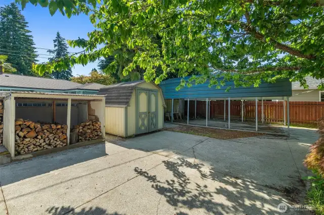 Large carport for extra vehicles, boat, etc. as well as shed to store garden tools and lawnmower.