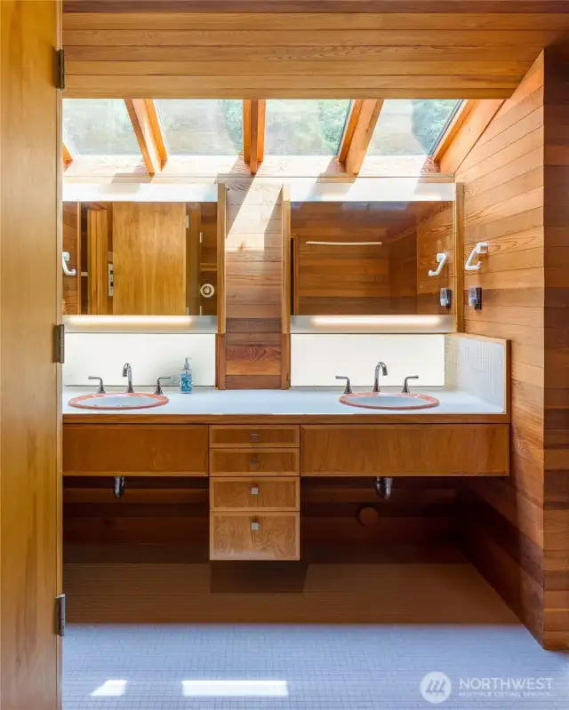 Dual sinks in the primary bath with recently tiled floors.