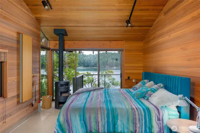 Guest room has freestanding stove, vaulted ceilings, and an amazing view.