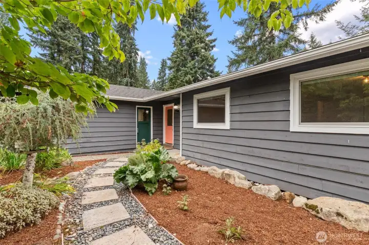 Stepping-stone path and low-maintenance landscaping leading to the door.